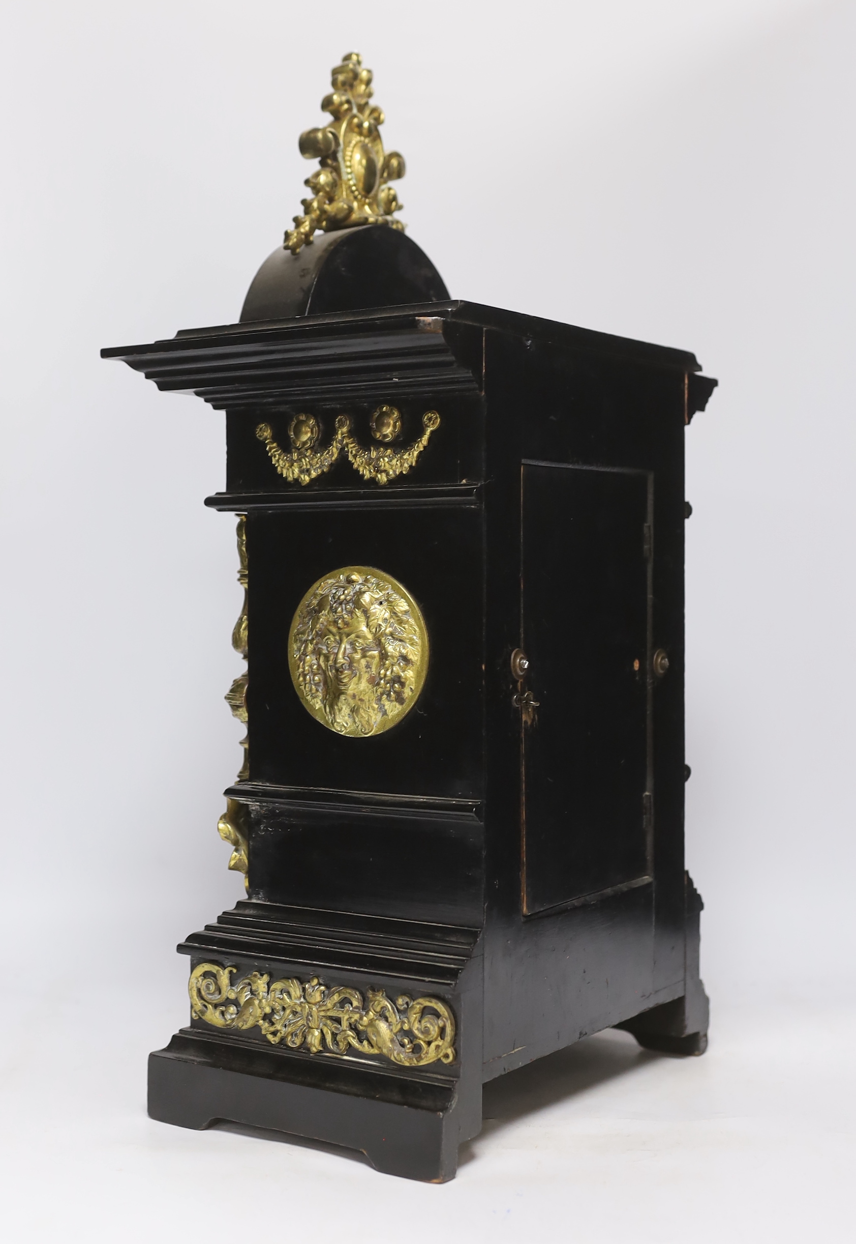 An ebonised German bracket clock with brass decoration, with a Lenzkirch movement striking on a coiled gong, 53cm high, with bracket